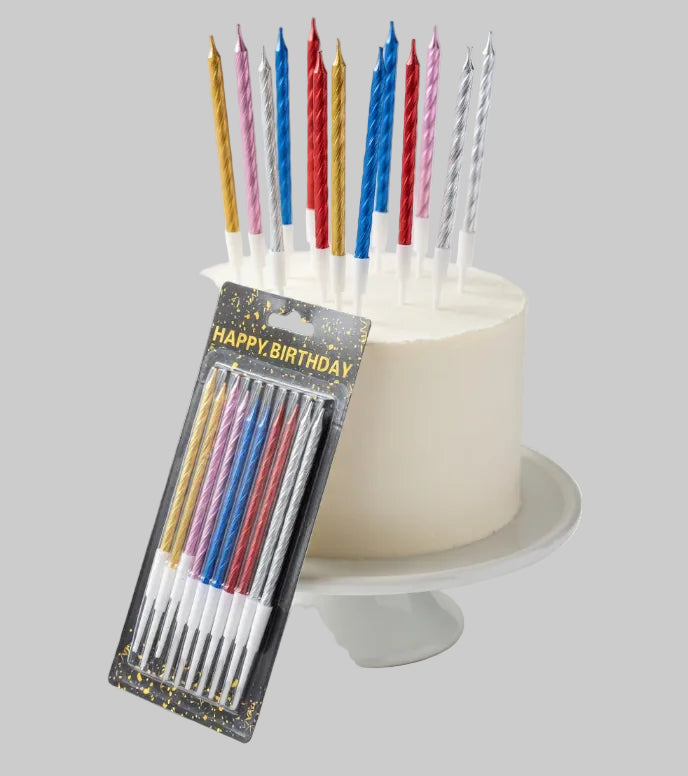 Colorful birthday candles on a cake with a package labeled 'Happy Birthday' in the foreground.